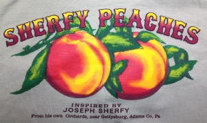 T-shirts, peach taffy, and aprons, adorned with the Sherfy Peach Orchard logo, are now for sale at the Gettysburg Visitors Center.